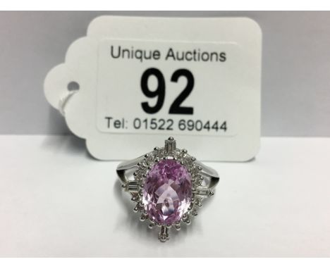 A Kunzite gem set ring with brilliant and baguette diamonds to surround in 18ct white gold