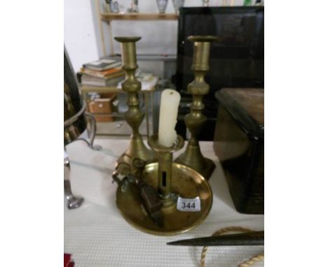 A pair of brass candlesticks, a brass chamber stick and a pair of candle snuffers