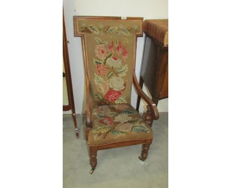 A mahogany framed chair with tapestry seat and back