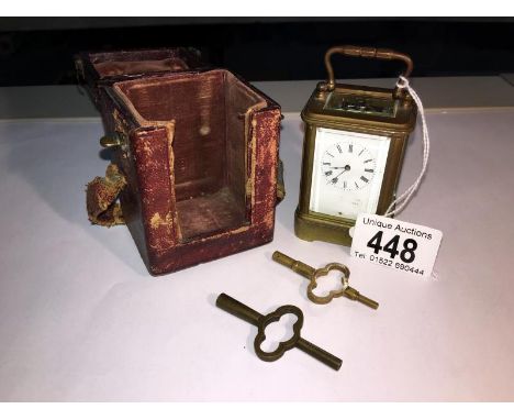 A miniature brass carriage clock in original case in working order