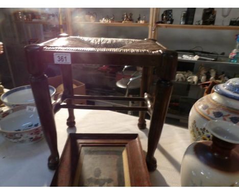 A 19th century oak stool with rush seat