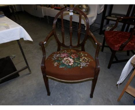 A mahogany elbow chair with tapestry seat