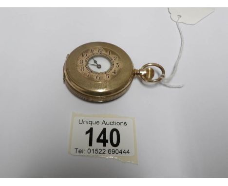 A gold filled half hunter pocket watch with enamel dial (missing glass)