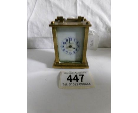 A miniature brass carriage clock in working order