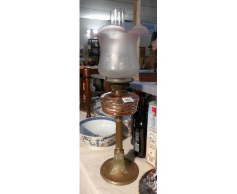 A oil lamp with brass base, brass column, glass font and etched shade