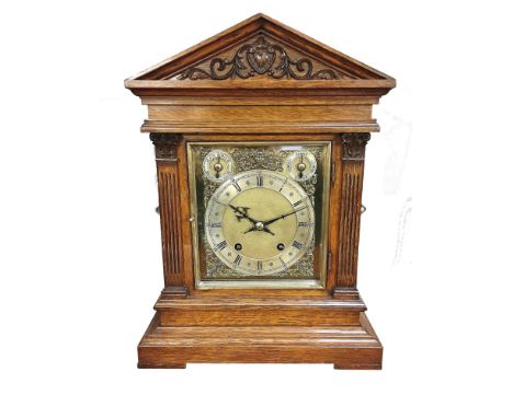 An oak bracket clock with brass dial