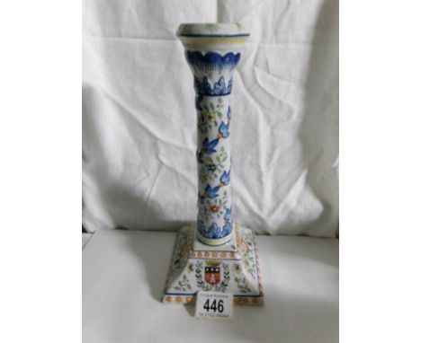 A hand painted ceramic candlestick with coat of arms