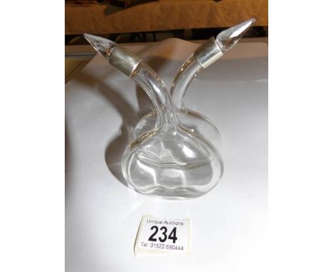 A silver topped oil/vinegar bottle