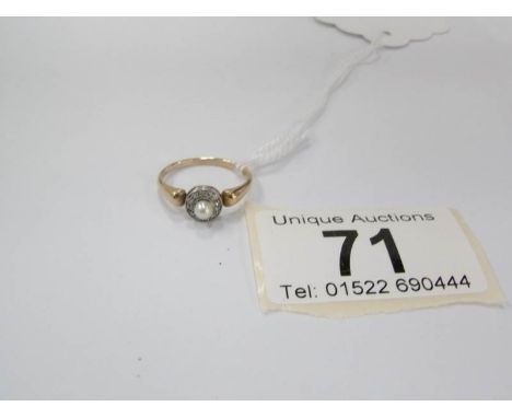 A 1930's diamond cluster ring set with old cut diamonds and centre pearl, size J