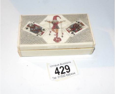 A bone case containing a full pack of bone playing cards with jesters on lid