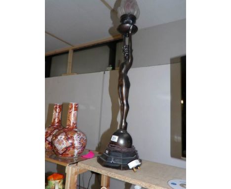 A tall art deco style spelter figurine lamp with flame glass shade