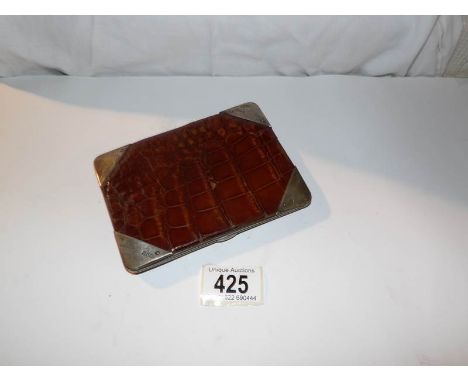 A crocodile skin wallet with hall marked silver corners