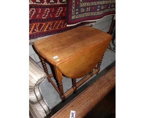 An oak barley twist gate leg table