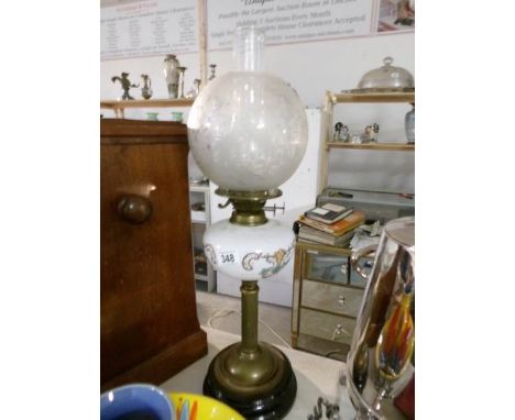 An oil lamp with brass column, pot base, opaque glass font and acid etched shade