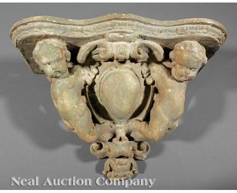 French Carved Wood and Plaster Figural Bracket Shelf, late 19th c., shaped shelf above winged cherubs and cabochon, h. 10 1/2