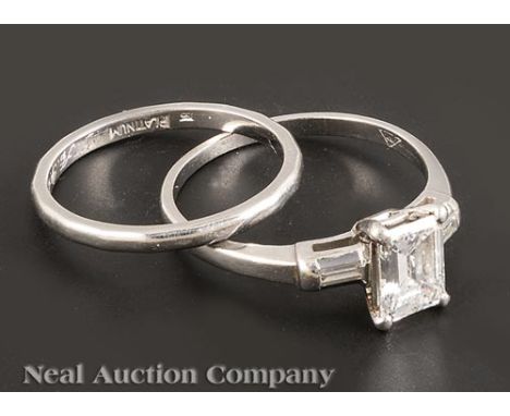 Platinum and Diamond Solitaire Ring, set with 1 emerald cut diamond, approx..95 ct., color H-I, clarity VS1-VS2, and 2 baguet