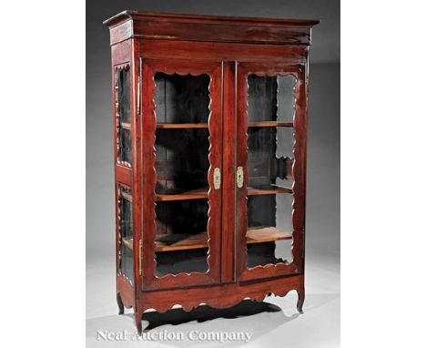 Louisiana Carved Mahogany Armoire, early 19th c. and later, molded cornice, scalloped doors and sides with later glazed panel