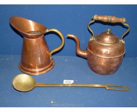 A copper kettle and jug and a long handled brass ladle.
