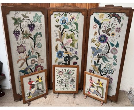 A large embroidered three fold screen / room divider decorated with flowers and leaves together with a similar fire screen an