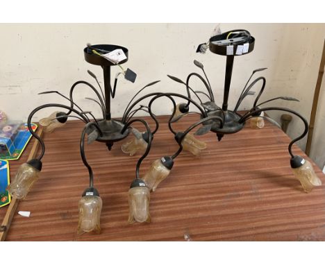 A pair of five light chandeliers with glass flowerhead shades