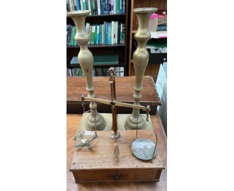 A pair of brass candlesticks together with a mahogany and brass folding scales 
