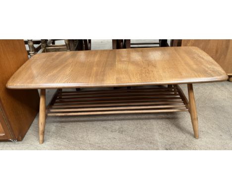 An Ercol light elm coffee table with a rectangular top on tapering legs 