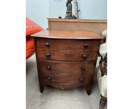 A 19th century mahogany commode in the form of a chest of drawers with a hinged top on splayed bracket feet