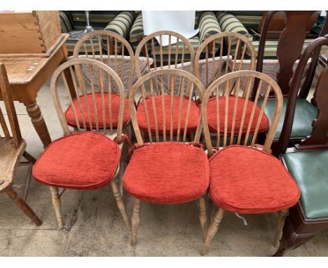 A set of six stick back dining chairs with solid seats on turned legs 