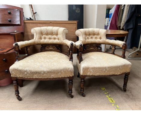 A pair of Edwardian horseshoe shaped chairs, with button back upholstered inlaid with and swags on tapering legs