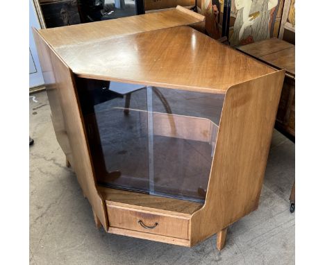 A mid 20th century teak corner unit with glazed doors, matching bookcase and corner shelf unit and an oak sewing cabinet   