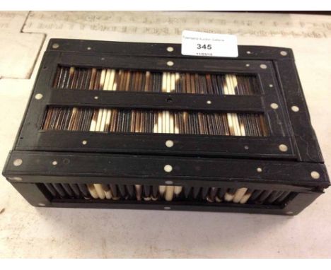 An Indian porcupine quill & ebony trinket box with sliding lid, inlaid with bone discs.  