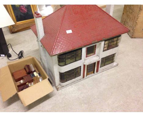 A vintage dolls house with Deco style curved windows, with assorted furniture - dated Christmas 1948  