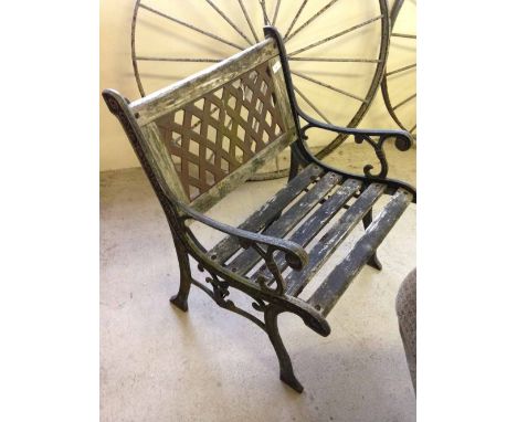 A single seater garden bench with cast iron ends and wooden slat seat.  