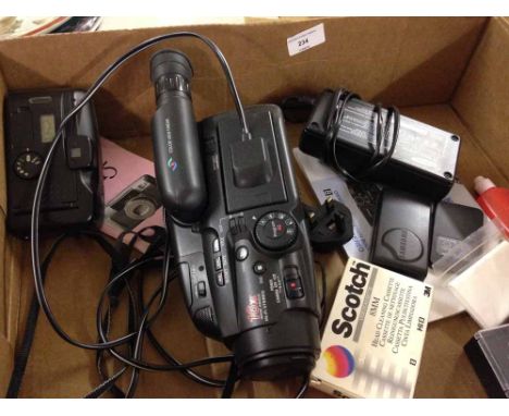 A Samsung VP-K85 video camera and accessories with a Canon Sure Shot Z115 camera.  