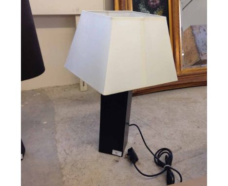 A designer table lamp by Aimbry, black pedestal and cream shade.  