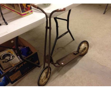 A vintage metal toy scooter.  