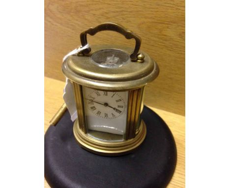 Miniature brass oval carriage clock.  