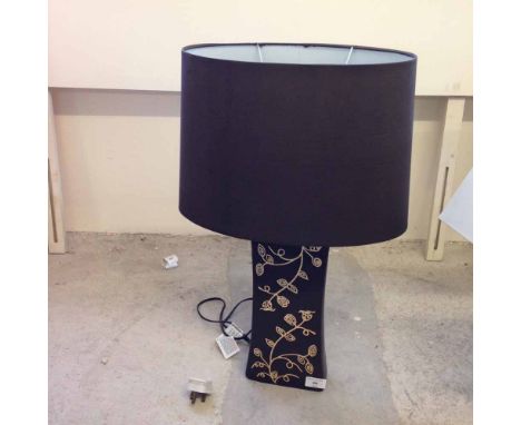 A designer table lamp with brown pedestal decorated with cream leaves & brown shade.  