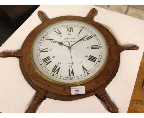 A modern ship's wheel wall clock  