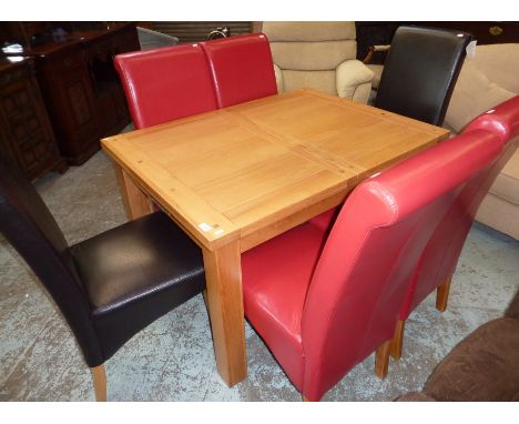 Light oak extending dining table and a set of 4 and 2 similar leather dining chairs with light oak supports