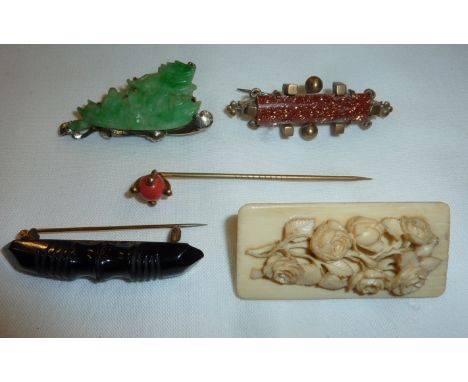 Carved bone floral brooch, jade brooch depicting oriental boat, coral stick pin and 2 others