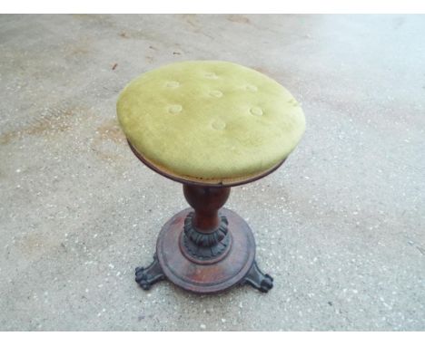 A button upholstered piano stool on carved support with tripod base, 52 cm (a/f)