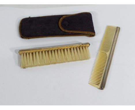 A brush and comb set with silver mounts, in wallet