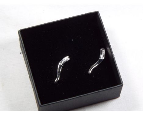 A lady's pair of 9 carat white gold 10 pt diamond set stick earrings, approx weight 1.1 gm unused surplus retail stock - Est 