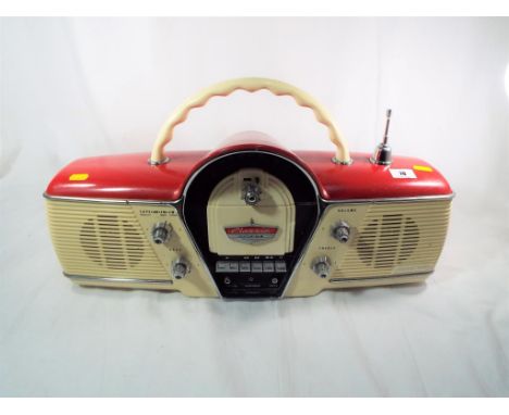 A Cicena vintage radio, model No. 261 with antennae, tuning knobs and carry handle and a tape recorder deck