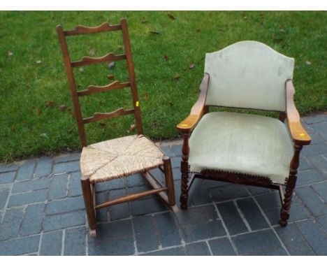 A carved oak armchair with green upholstery and a ladder back rocking chair (2)