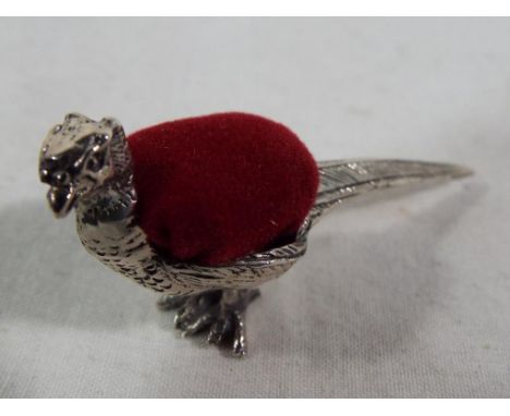 A pheasant pin cushion stamped 925. Estimate £30 - £50