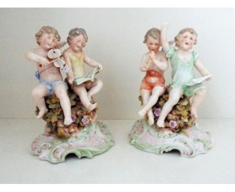 Two 19th century European ceramic figural groups modelled as putti on a scrolled base, each approx. 14 cm (high)