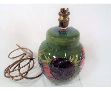 Moorcroft - a Moorcroft lamp decorated in the green and anemone pattern 27 cm (h). Estimate £130 - £160