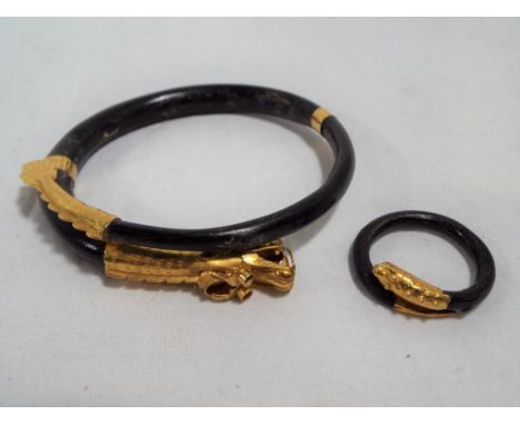 A bangle (6 cm diameter) and ring (2 cm diameter) in horn and 22ct gold, set with dragon and snake heads and tails, Est £150 